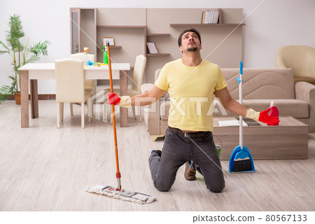 Young male contractor cleaning the house 80567133