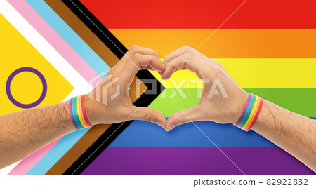 male hands with gay pride wristbands showing heart 82922832