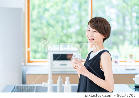 Female hydrating in the kitchen 86175705