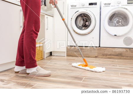 Cleaning floor in laundry room in modern house 86193730