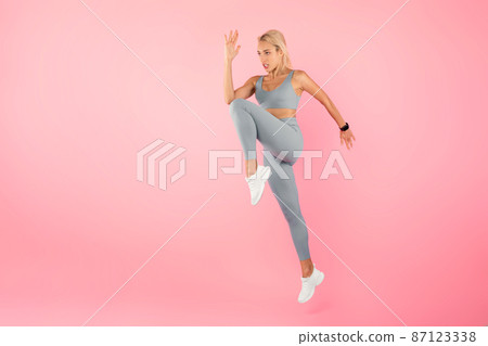 Young Woman Jumping And Exercising Isolated On Pink Background 87123338