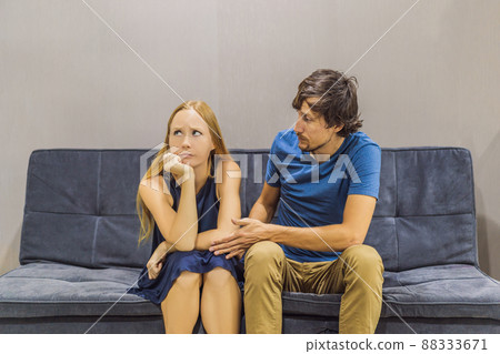 Young couple swears on the couch. Watch and evaluate their behavior from the side. Emotional intelligence concept 88333671