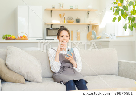 A woman relaxing on the sofa, a housewife, mom 89970891