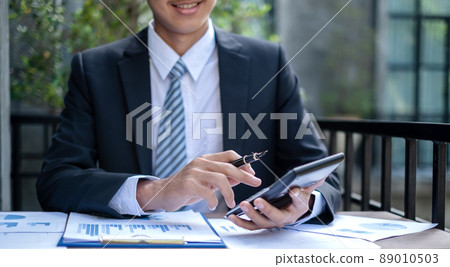 Young businessman financial market analyst sits at their desks and calculate financial graphs showing the results of their investments planning the process of successful business growth 89010503