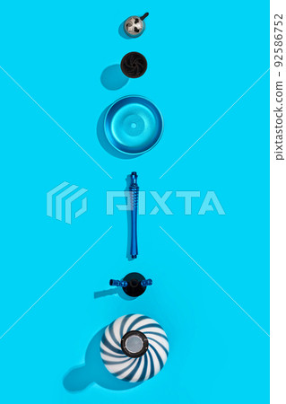 Parts of blue decorated hookah or shisha on light blue backgroun 92586752