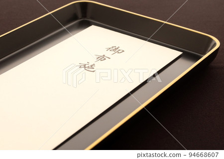 An offering envelope given to a monk on a tray Image of the cost of a funeral funeral 2 94668607