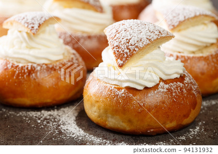 Sweet buns with frangipane and whipped cream close-up. Horizontal 94131932