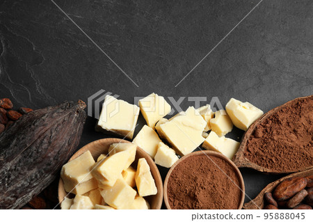 Flat lay composition with organic cocoa butter on black table. Space for text 95888045