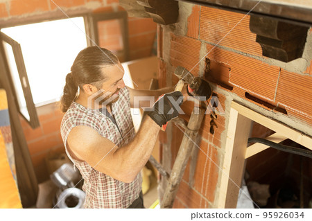 Strong man making a groove to put wiring 95926034