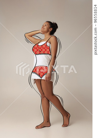 Natural beauty. Artwork with young slim girl wearing drawn underwear isolated over light background. Drawings of overweight lines around body. Concept of healthy eating, dieting, wellness. 96558814