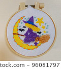 Illustration embroidery A witch and a bat flying on a broom in the moonlit night 96081797