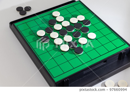 Othello board and black and white stones 97660994