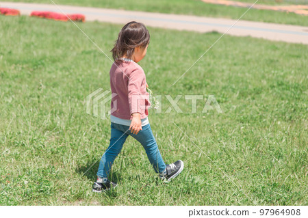 Back view of an Asian child playing in the park (no face) 97964908