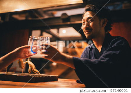 Bearded man drinking alcohol by the hearth 97140001