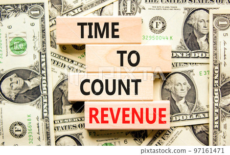 Time to count revenue symbol. Concept word Time to count revenue on wooden blocks. Beautiful background from dollar bills. Business and time to count revenue concept. Copy space. 97161471