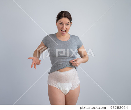 A woman in adult diapers. Urinary incontinence problem. 98268024