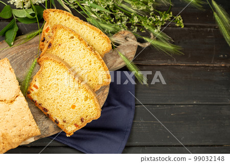 Tasty Sliced Home Baked Bread on Wooden Background 99032148