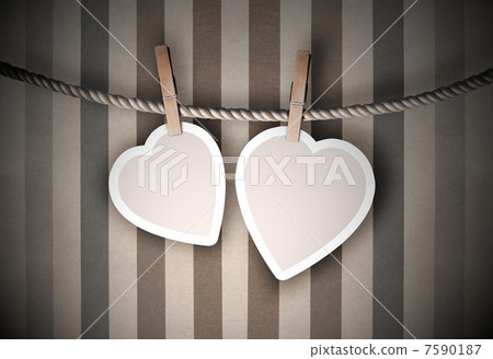 Paper hearts hanging on a rope on grunge background 7590187