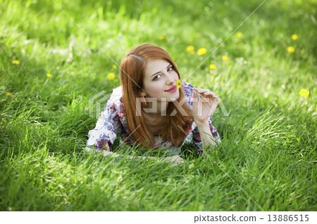 Beautiful girl lying down at grass. 13886515