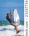 Athletic man riding on kite surf board sea waves 23297734