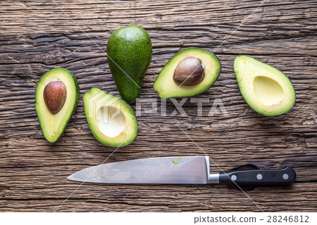 Avocado.Cut avocado on a oak wood background table 28246812