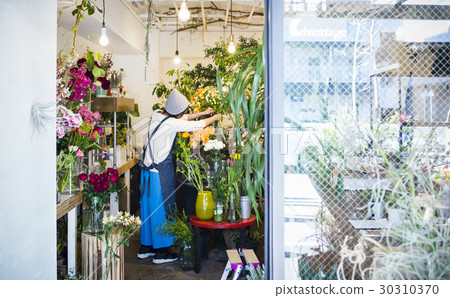 Female staff in a flower shop 30310370