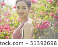 Young woman with happy face in flower garden 31392698