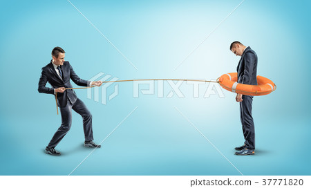 A businessman catches another man with an orange 37771820