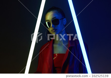 beautiful young woman with neon lamp 102525139