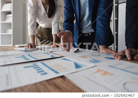 Asian business adviser meeting to analyze and discuss the situation on the financial report in the meeting room. Investment Consultant, Financial Consultant and accounting concept 102692467