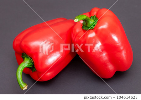 Red Bell Peppers on Black Background 104614625