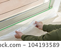 Man masking before applying window glass film 104193589