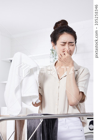 summer lifestyle, korean asian young woman concerned about the smell of laundry 105258346