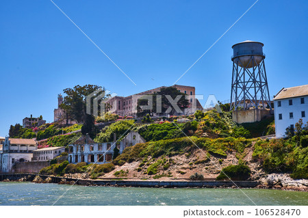 East side of Alcatraz Island close up with prison and water tower view on bright summer day 106528470