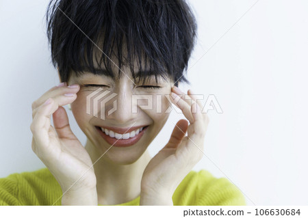 Smiling young woman in yellow clothes against white background 106630684