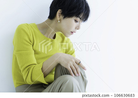 Fashion portrait of young woman in yellow clothes on white background 106630683