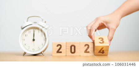 Happy New Year with vintage alarm clock and flipping 2023 change to 2024 block. Christmas, New Start, Resolution, countdown, Goals, Plan, Action and Motivation Concept 106031446