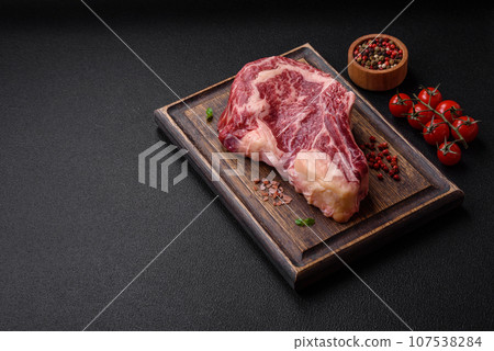 Fresh juicy raw beef striploin steak with salt and spices 107538284