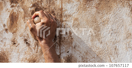 Mud race runners, obstacles during extreme obstacle race. Detail of a hand overcoming an obstacle 107657117