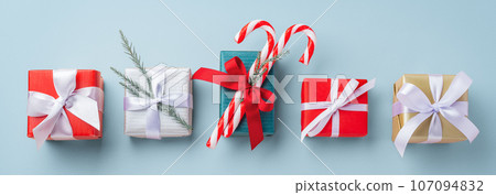 Gift box collection with christmas decoration on blue background, top view 107094832