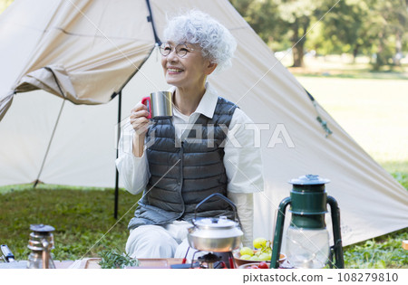 Cute lady enjoying camping 108279810