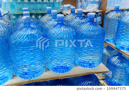 Bottles with clean water in a hyper package. Sale of drinking water. Selective focus 109947375