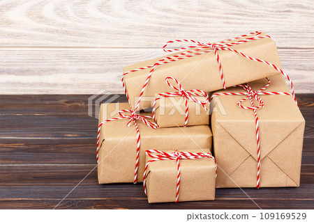 Stack of handcraft gift boxes on wooden board with a natural textured background 109169529