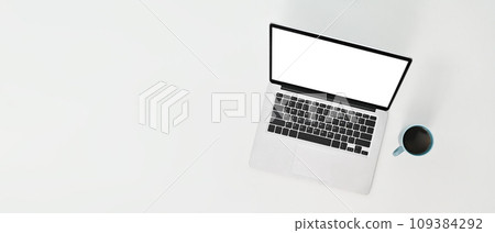 Laptop computer and cup of coffee on white background. Flat lay with blank copy space 109384292