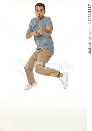 happy guy looking pointing at the camera on white studio background 110823317