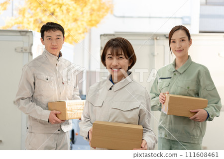 Men and women in work clothes carrying luggage 111608461