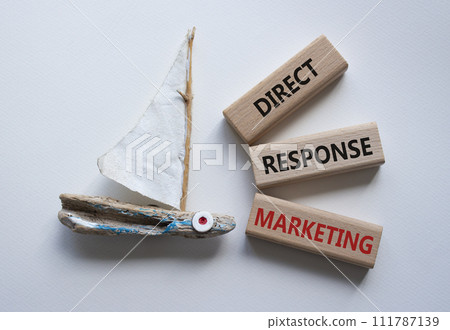 Direct Response Marketing symbol. Concept words Direct Response Marketing on wooden blocks. Beautiful white background with boat. Business and Direct Response Marketing concept. Copy space. 111787139