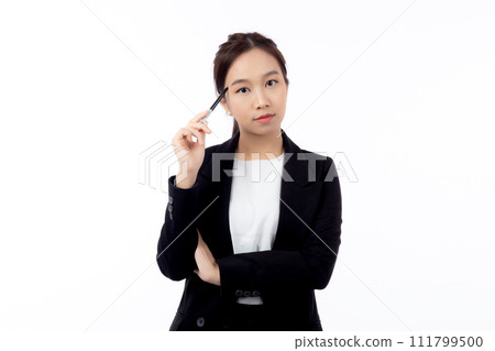 A thoughtful professional young asian woman holding a pen to her face, contemplating. 111799500