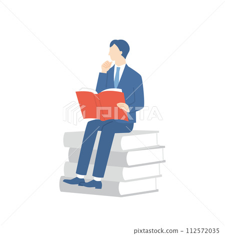 Businessman sitting on a book and reading 112572035