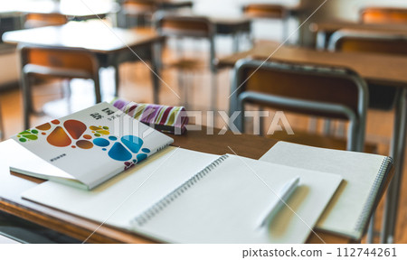 Textbooks and notebooks placed on classroom desks 112744261